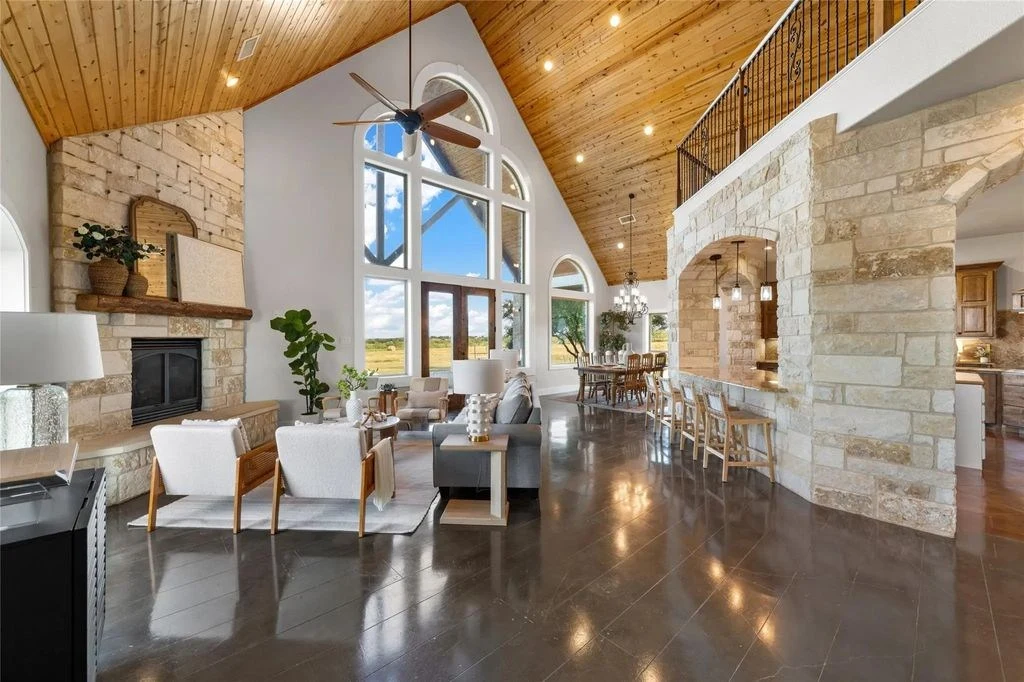 Rogers residence great room with timber ceiling and stone fireplace